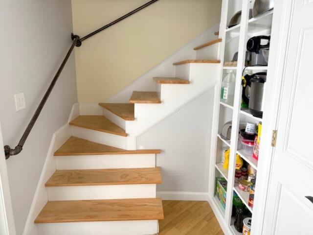 stairway featuring wood finished floors