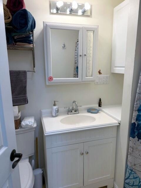 full bath with toilet and vanity