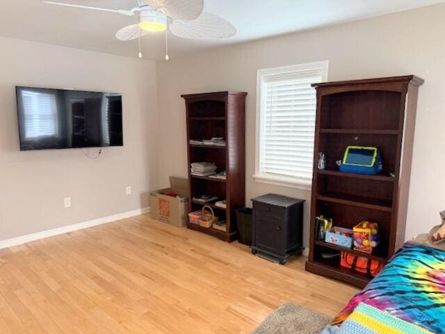 bedroom featuring light wood finished floors, ceiling fan, and baseboards