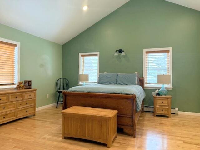 bedroom featuring light wood-type flooring, baseboards, high vaulted ceiling, and a baseboard radiator