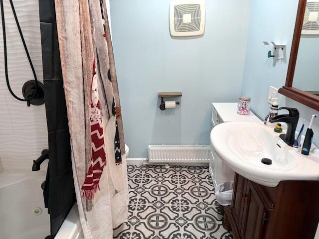 bathroom with baseboards, shower / bath combination with curtain, vanity, and tile patterned flooring