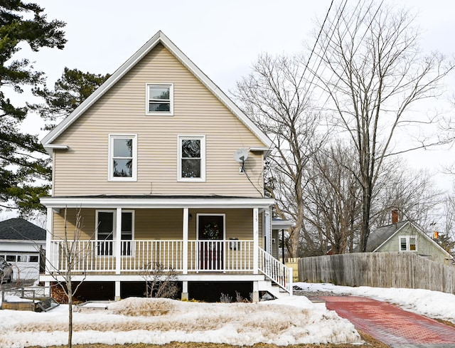 view of front of home featuring a porch and fence