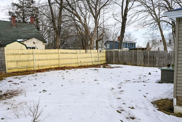 yard layered in snow featuring fence private yard