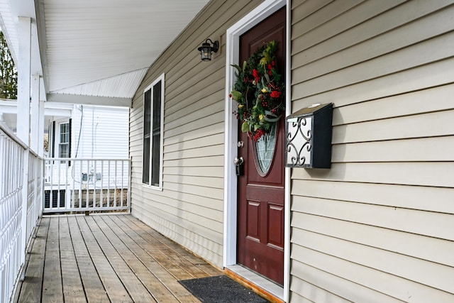 view of exterior entry featuring covered porch