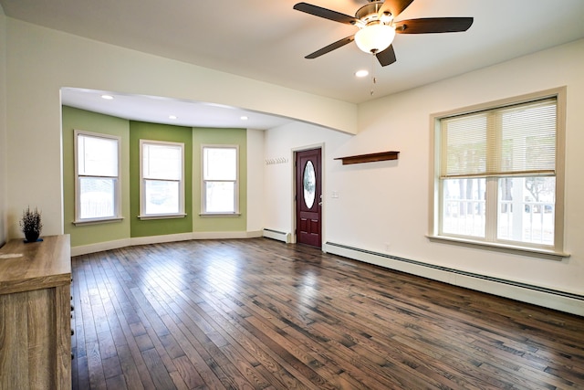 unfurnished living room featuring baseboard heating, recessed lighting, baseboards, and dark wood-style flooring