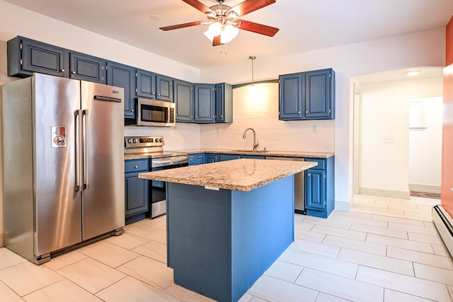 kitchen featuring backsplash, blue cabinetry, stainless steel appliances, and a sink