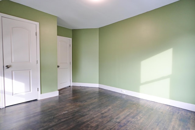 empty room featuring baseboards and wood finished floors