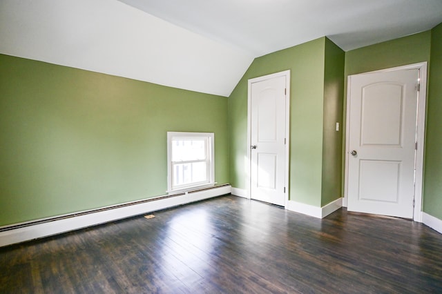 additional living space featuring vaulted ceiling, wood finished floors, baseboards, and baseboard heating