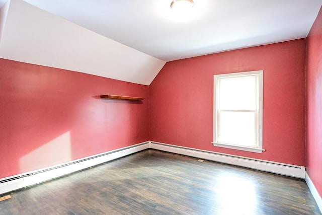 additional living space with vaulted ceiling, wood finished floors, and baseboard heating