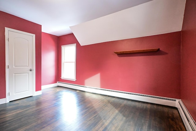 additional living space featuring baseboards, dark wood-style flooring, and baseboard heating