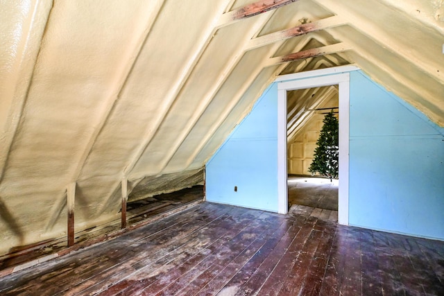 additional living space featuring lofted ceiling and hardwood / wood-style floors