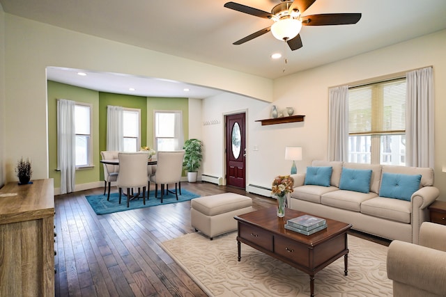 living area featuring recessed lighting, a baseboard heating unit, baseboards, and hardwood / wood-style flooring