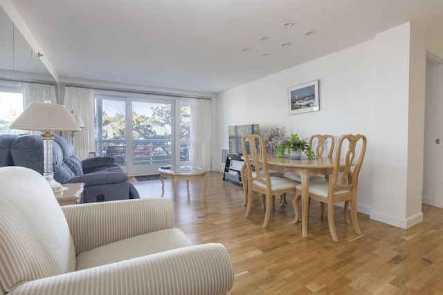 dining area featuring light wood-type flooring and baseboards