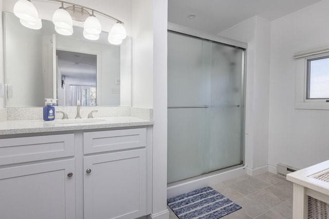 bathroom with vanity, baseboard heating, a shower stall, and tile patterned flooring