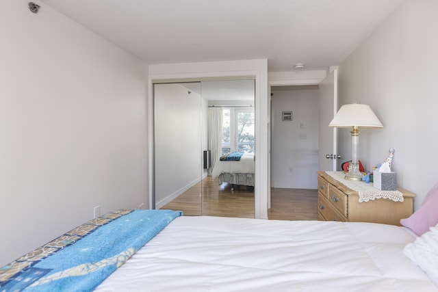 bedroom featuring a closet and wood finished floors