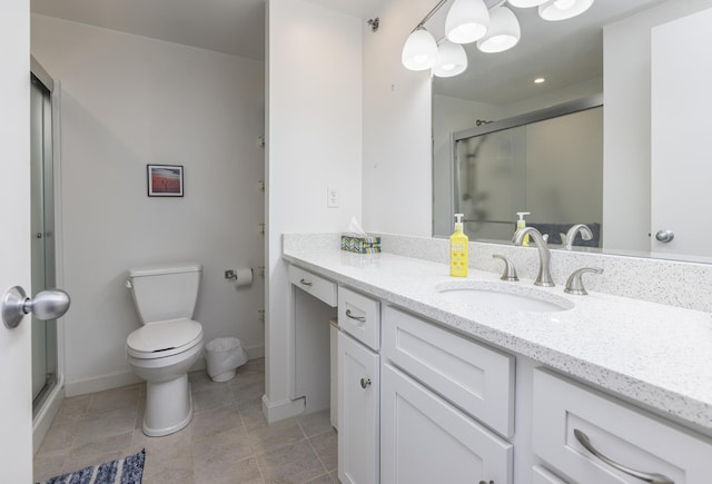 full bathroom featuring tile patterned floors, toilet, a stall shower, baseboards, and vanity