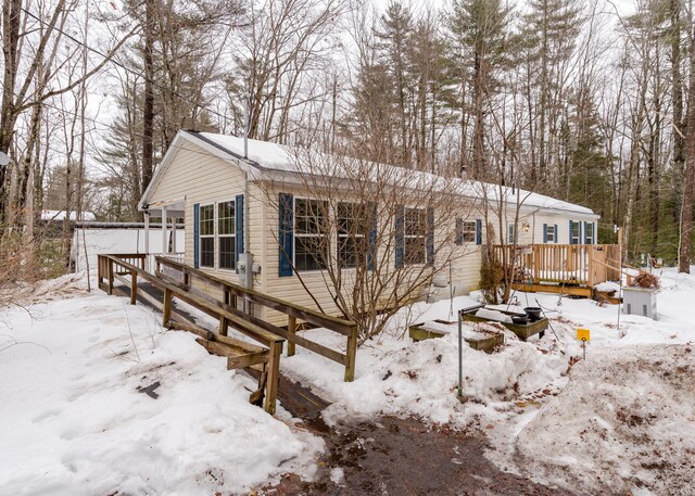 view of front of property featuring a garage and a wooden deck