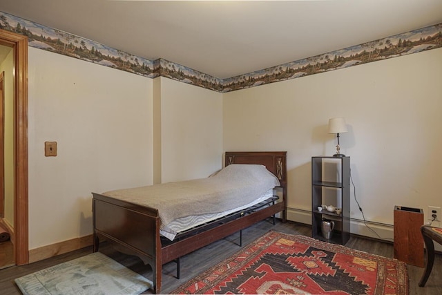 bedroom featuring wood finished floors, baseboards, and baseboard heating