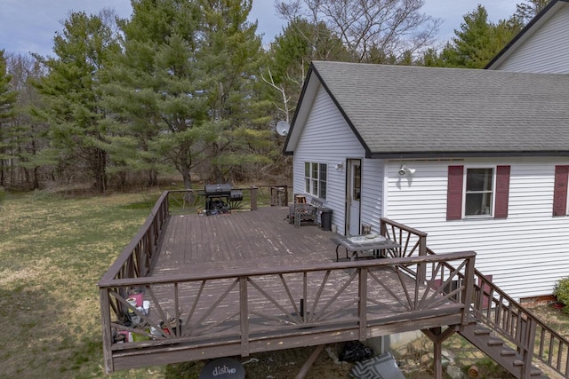 wooden deck featuring grilling area and a yard