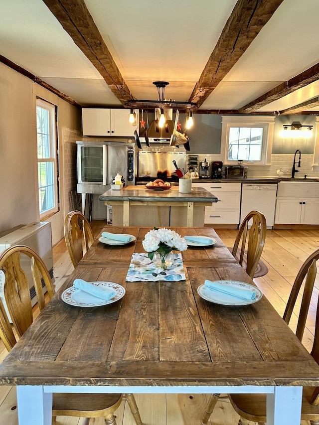 286 Lexington Rd, Kingfield, ME 04947 - dining area with light wood-style floors, beamed ceiling, and plenty of natural light