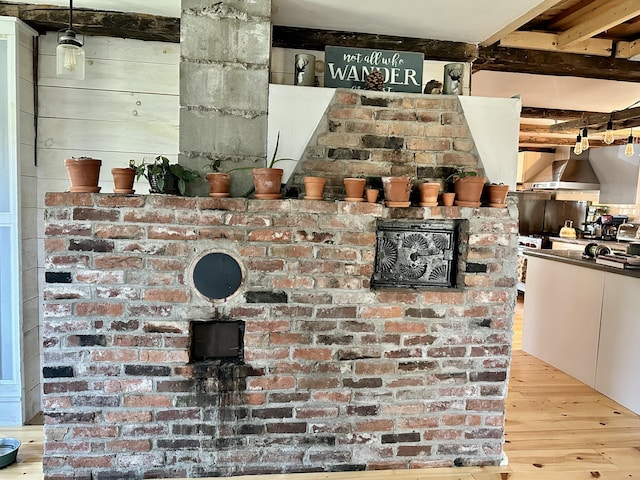 286 Lexington Rd, Kingfield, ME 04947 - detailed view of wall chimney exhaust hood, wood finished floors, and beamed ceiling