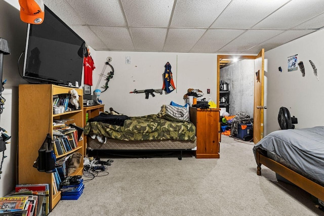 bedroom with carpet flooring and a paneled ceiling