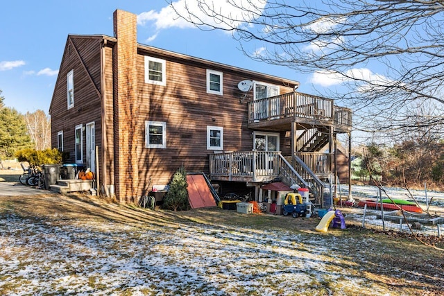 back of house featuring a wooden deck and a chimney