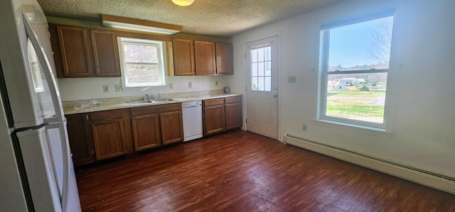 8 Cornerbrook Cir, Windham, ME 04062 - kitchen with a sink, light countertops, a baseboard radiator, white appliances, and dark wood-type flooring