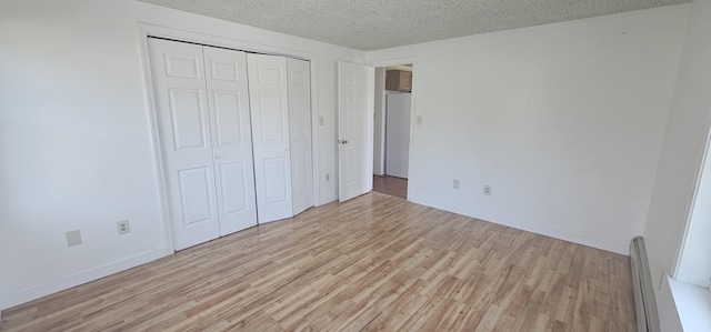 8 Cornerbrook Cir, Windham, ME 04062 - unfurnished bedroom featuring baseboards, a closet, light wood-type flooring, and a textured ceiling