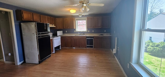 8 Cornerbrook Cir, Windham, ME 04062 - kitchen featuring light wood-type flooring, a sink, light countertops, freestanding refrigerator, and white range with electric stovetop