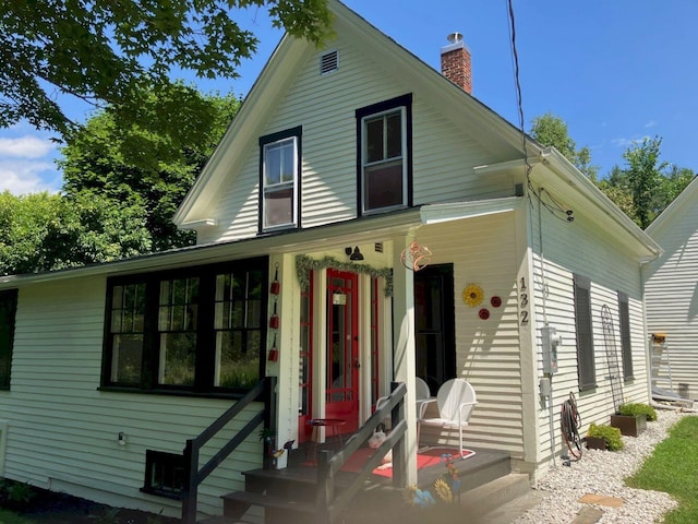 view of front of house featuring a chimney