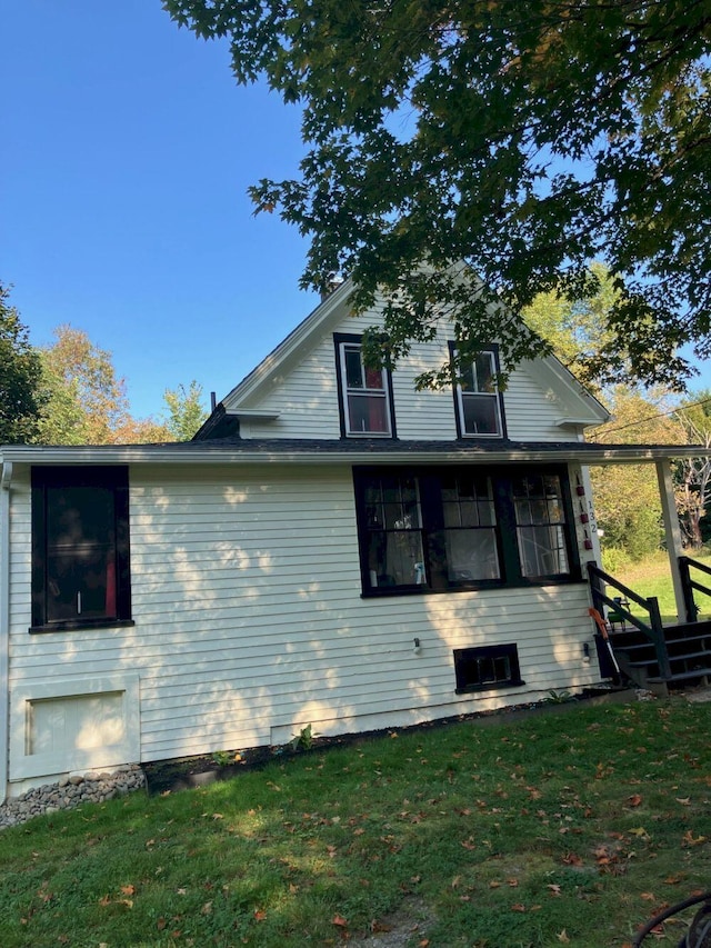 view of side of home featuring a yard