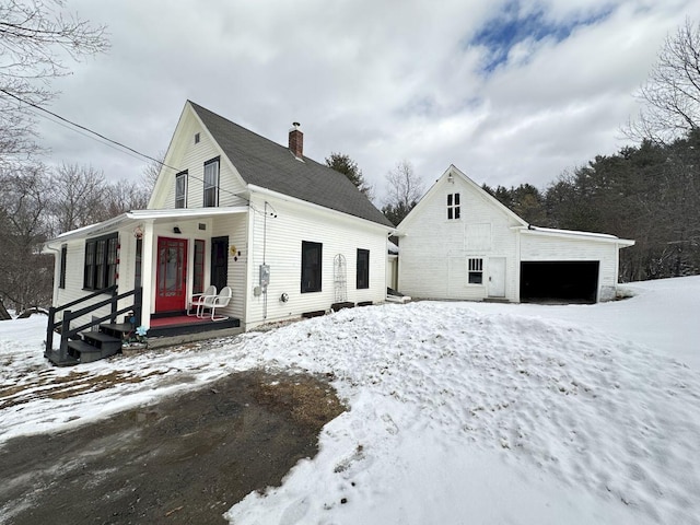 view of front facade featuring covered porch and a chimney