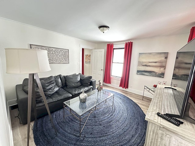 living room with baseboards and wood finished floors