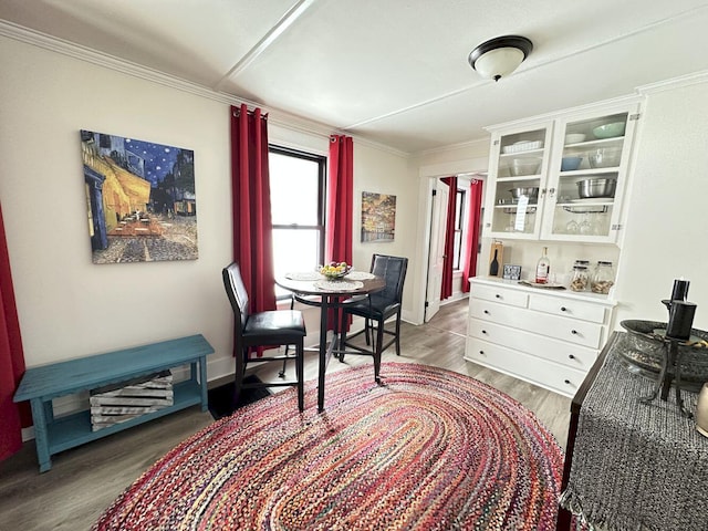 interior space with light wood-style flooring, crown molding, and baseboards