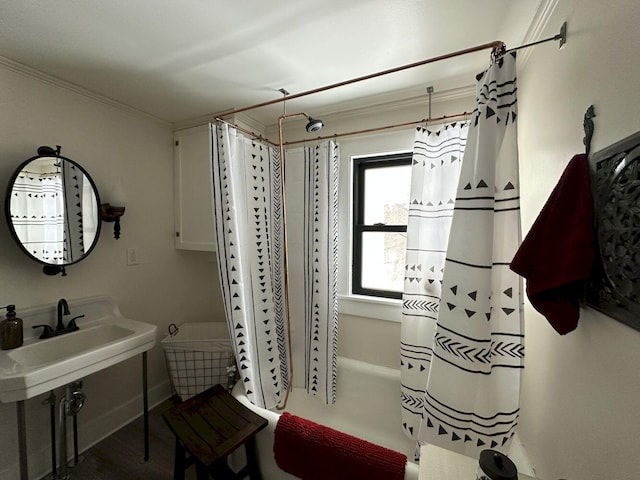 bathroom with a sink, ornamental molding, and shower / bath combo