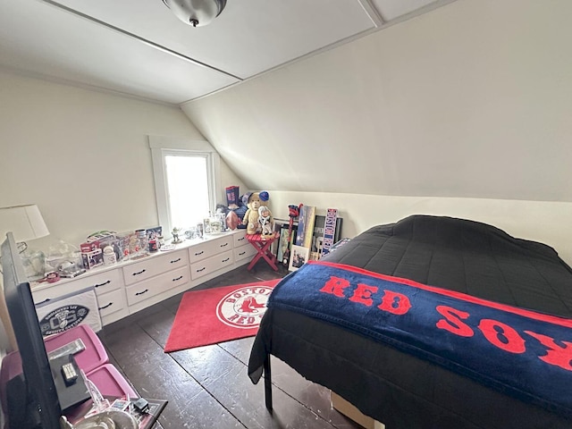 bedroom featuring dark wood-type flooring and vaulted ceiling