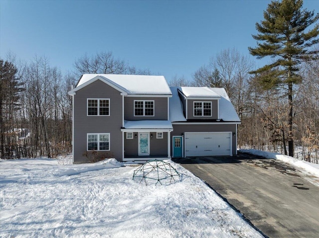 view of front of property with aphalt driveway and a garage