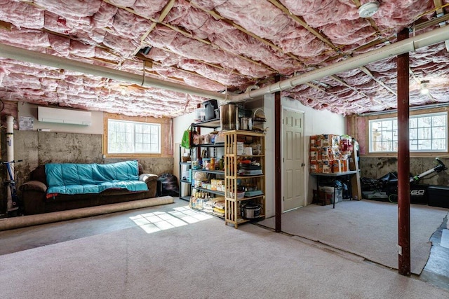 basement with carpet floors and an AC wall unit