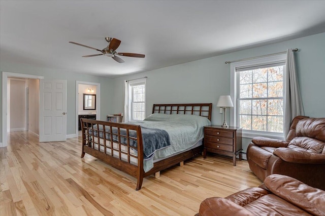 bedroom with baseboards, light wood-style floors, and ceiling fan