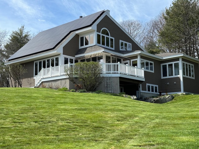 189 Mills Rd, Kennebunkport, ME 04046 - rear view of property with a lawn, solar panels, and a wooden deck