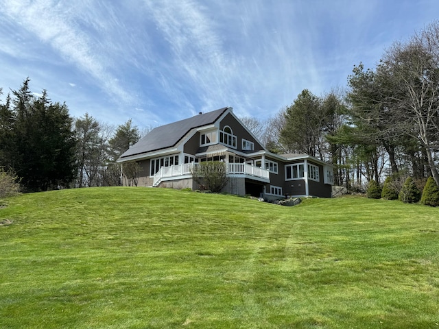 189 Mills Rd, Kennebunkport, ME 04046 - back of property featuring a deck, solar panels, and a lawn