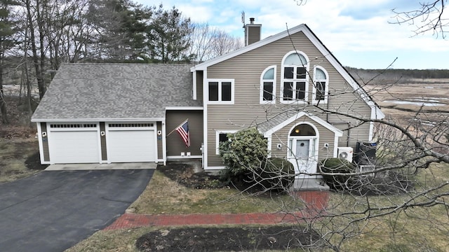 189 Mills Rd, Kennebunkport, ME 04046 - view of front of home featuring a chimney, a garage, aphalt driveway, and roof with shingles