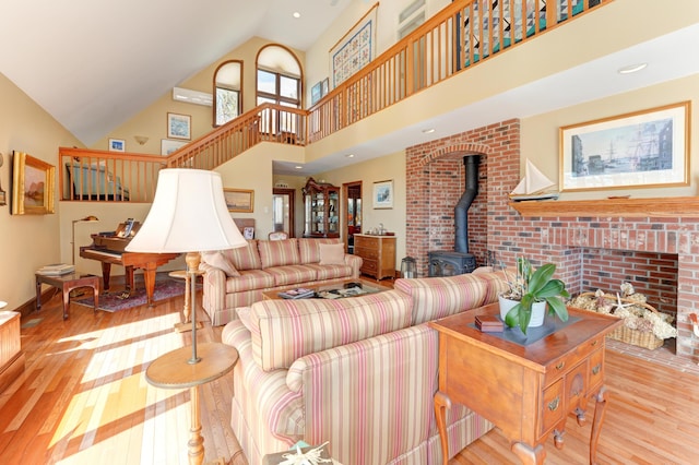 189 Mills Rd, Kennebunkport, ME 04046 - living area with a wood stove, stairs, hardwood / wood-style floors, and high vaulted ceiling
