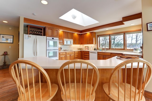 189 Mills Rd, Kennebunkport, ME 04046 - kitchen with recessed lighting, a skylight, white appliances, and light countertops