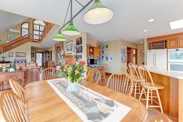 189 Mills Rd, Kennebunkport, ME 04046 - dining area with light wood-style floors, recessed lighting, stairs, and a skylight