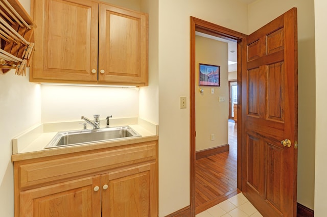 189 Mills Rd, Kennebunkport, ME 04046 - kitchen with light brown cabinetry, light countertops, a sink, baseboards, and light tile patterned flooring