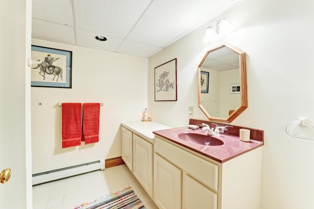 189 Mills Rd, Kennebunkport, ME 04046 - bathroom featuring a baseboard heating unit, tile patterned flooring, a drop ceiling, and vanity