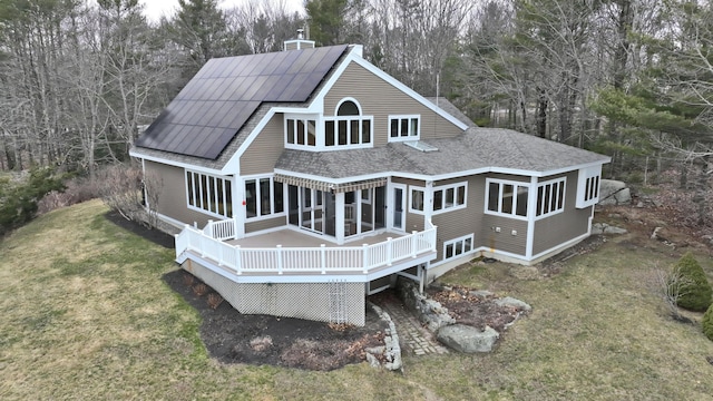 189 Mills Rd, Kennebunkport, ME 04046 - back of house featuring a sunroom, a yard, a chimney, a deck, and roof with shingles