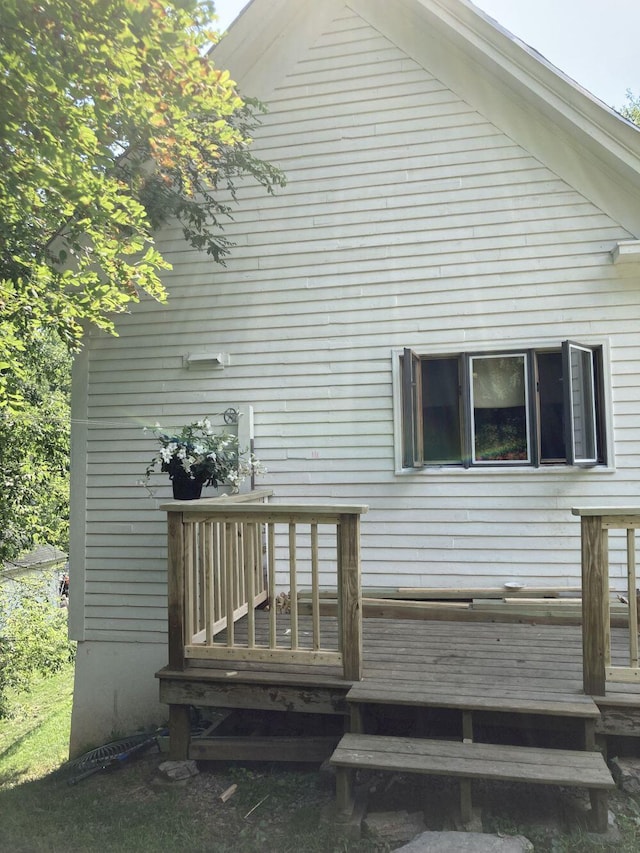 back of house with a wooden deck